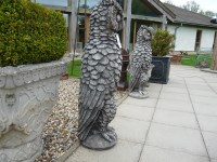 Lot 3050 - A pair of very large cast stone mythical owls