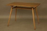 Lot 2050 - An Ercol elm dining table on slender supports