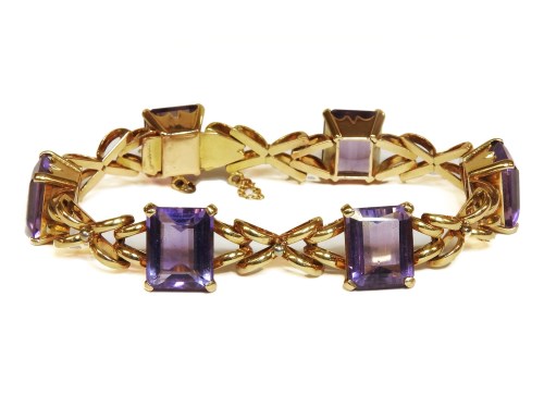 Lot 1025 - A gold emerald cut amethyst bracelet