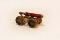 Lot 1068 - A pair of early 20th century French gilt metal and red enamel opera glasses