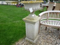 Lot 3013 - A reconstituted stone garden urn on a square plinth