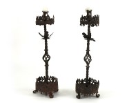 Lot 1513 - A pair of floor standing wrought iron candelabrum