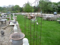 Lot 3035 - A pair of hand forged wrought iron square garden obelisks