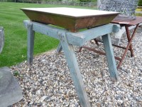 Lot 3147 - A cast iron and white enamelled sink on a green painted wooden stand