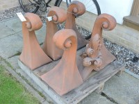 Lot 3168 - Six terracotta roof finials of scrolling form