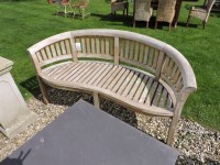 Lot 3137 - A curved slatted teak garden seat