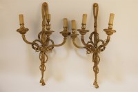 Lot 1601 - A pair of brass three light wall sconces