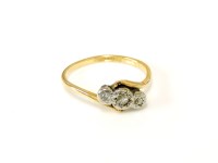 Lot 34 - A gold three stone diamond crossover ring