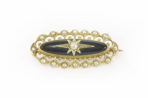 Lot 4 - A Victorian gold and black onyx cabochon and seed pearl brooch