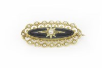 Lot 4 - A Victorian gold and black onyx cabochon and seed pearl brooch