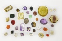 Lot 49 - A collection of gemstones and paste stones to include two mixed cut citrines
