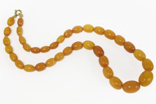 Lot 47 - A single row graduated olive shaped butterscotch amber bead necklace
22.45g