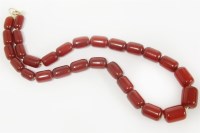 Lot 48 - A single row graduated cherry coloured Bakelite barrel bead necklace
39.74g