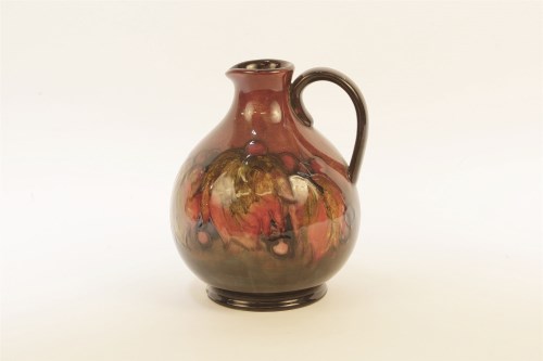 Lot 218 - A Moorcroft leaf and berry pattern jug in a flambe glaze
