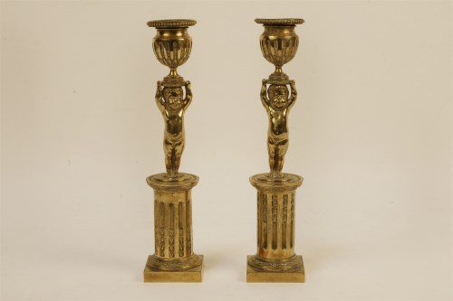Lot 132 - A pair of 19th century brass candlesticks