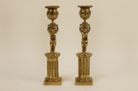 Lot 132 - A pair of 19th century brass candlesticks