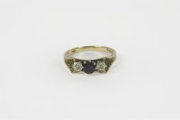 Lot 44 - A three stone sapphire and illusion set diamond ring