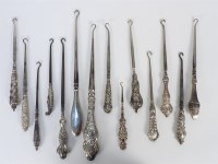 Lot 95 - A collection of fourteen silver mounted button hooks