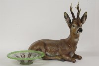 Lot 1559 - A terracotta reclining figure of a deer