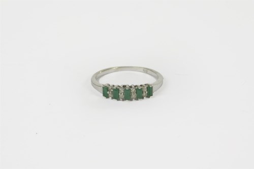 Lot 45 - A 9ct gold emerald and diamond half hoop eternity ring