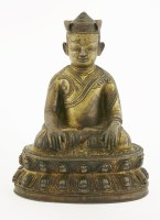 Lot 147 - A gilt bronze Tibetan figure