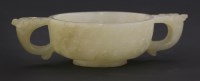 Lot 107 - A celadon jade two-handled cup