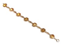 Lot 71 - A 9ct gold oval cut citrine and filigree openwork bracelet