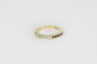 Lot 2 - An Egyptian gold diamond and ruby half eternity ring