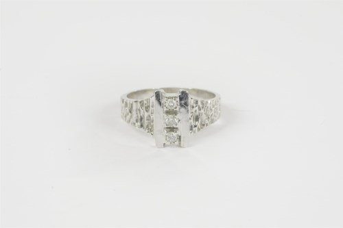 Lot 28 - A white gold three stone diamond ring
