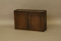 Lot 470 - An 18th century and later hanging oak cupboard of pegged construction