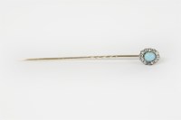 Lot 22 - A gold and silver turquoise oval cabochon and rose cut diamond cluster stick pin