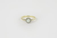 Lot 35 - A gold diamond and opal cabochon cluster ring
