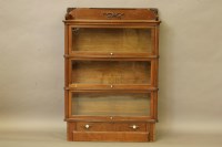 Lot 394 - A walnut sectional bookcase