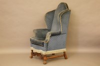 Lot 367 - A Queen Anne style blue upholstered wing back armchair