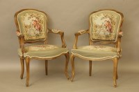 Lot 391 - A pair of Louis XV style beech wood fauteuils with embroidered upholstery