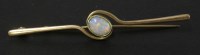 Lot 119 - A gold single stone semi-black opal bar brooch