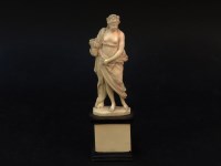 Lot 1286 - A late 19th century Dieppe ivory figure of a classical maiden holding a basket of flowers
