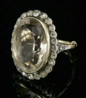 Lot 69 - An Austro-Hungarian near colourless quartz and diamond oval cluster ring