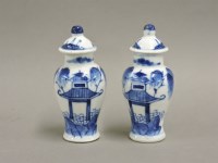 Lot 161 - A pair of miniature Chinese blue and white vases and covers