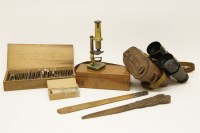 Lot 65 - A late 19th century cedar cased brass microscope