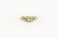Lot 1 - A gold single stone diamond ring with diamond set shoulders