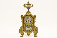 Lot 180 - A gilt metal and porcelain mantle clock