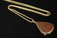 Lot 493 - A gold-mounted synthetic goldstone pendant and chain