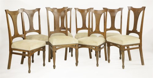 Lot 146 - A set of eight Arts and Crafts oak dining chairs