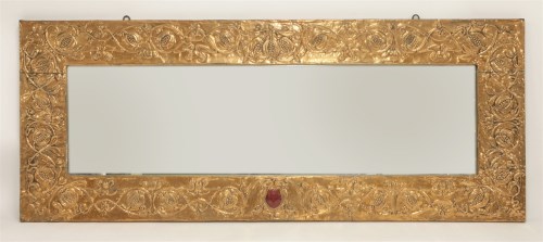 Lot 70 - An Arts and Crafts copper embossed overmantel mirror