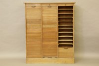 Lot 477 - A 20th century oak filing cabinet with tambour doors