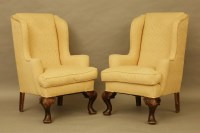 Lot 482 - A pair of George I style wingback armchairs