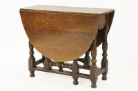 Lot 567 - A 19th century oak gate leg table