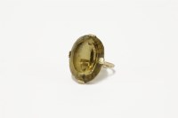 Lot 21 - A gold oval mixed cut smokey quartz ring