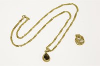 Lot 3 - A 9ct gold pear shaped smokey quartz pendant on a 9ct gold Singapore link chain